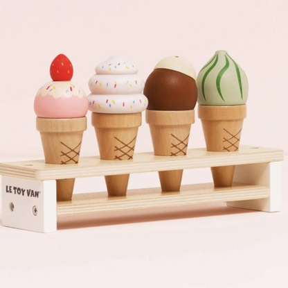 Toy ice cream cones on a stand with a pink background