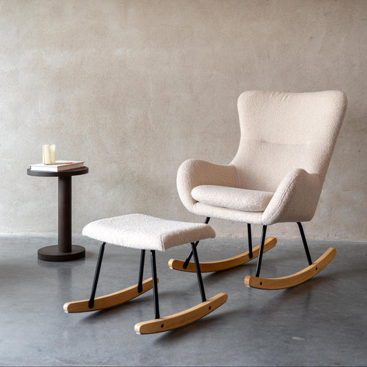 Beige Boucle rocking chair with ottoman on a concrete floor against a gray wall.