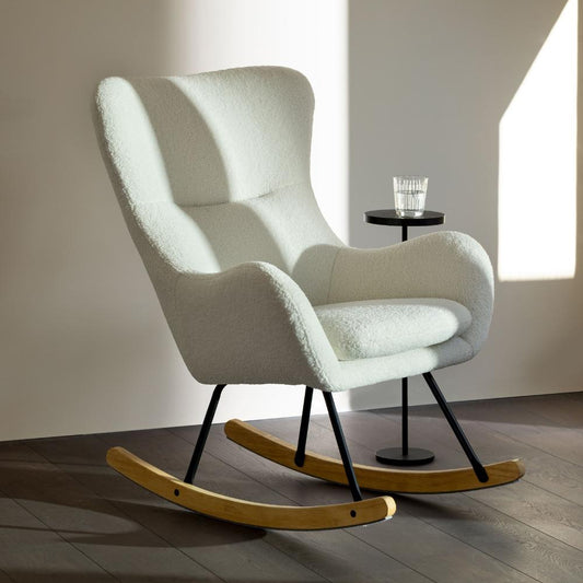 White nursing rocking chair with wooden base in a minimalistic room